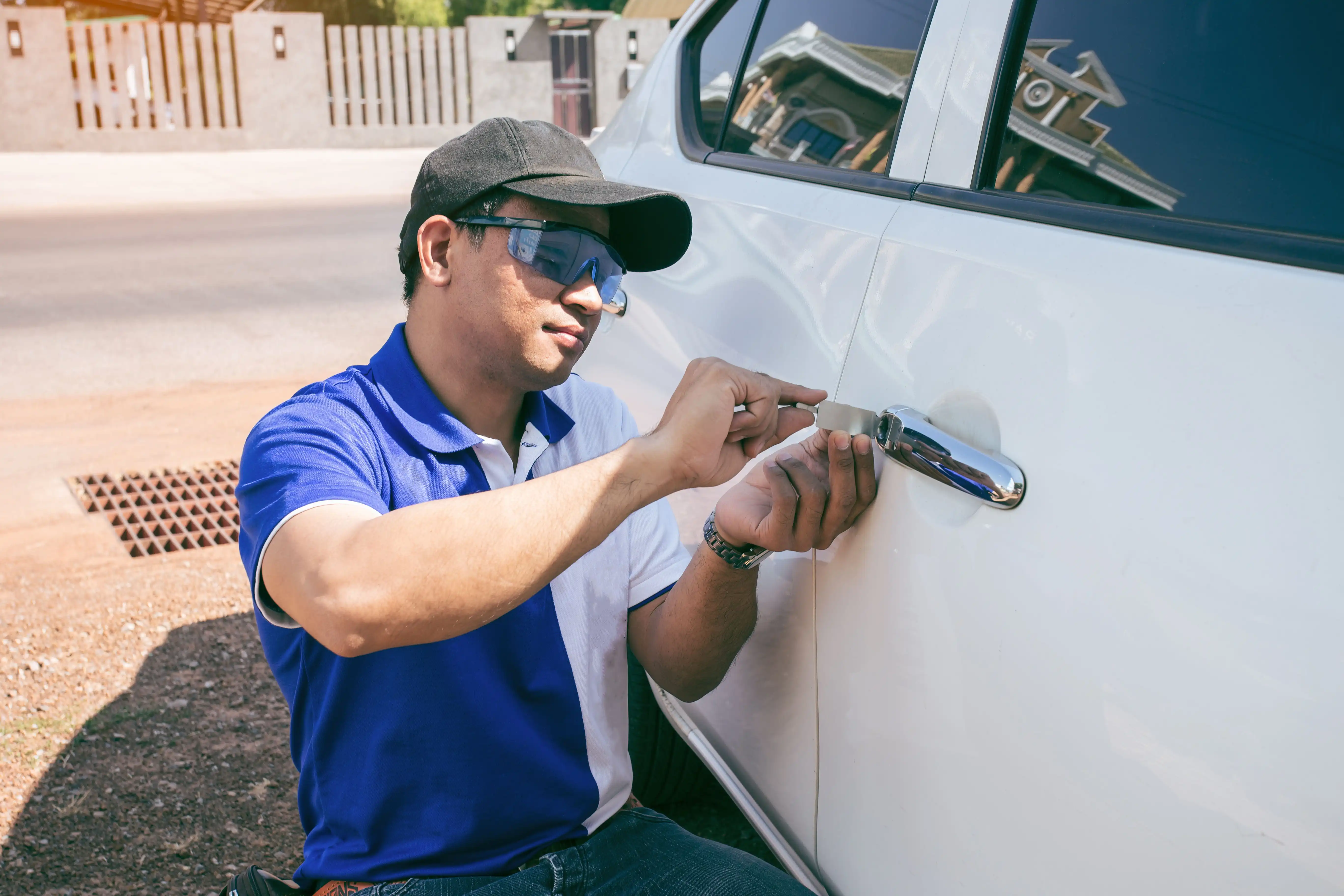 Locksmith opening a locked car door with a lockout tool in Charlotte, NC
